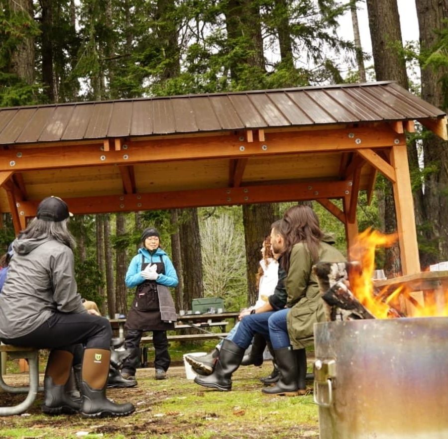 Founder Angela Shen talks to a group at an outdoor shelter