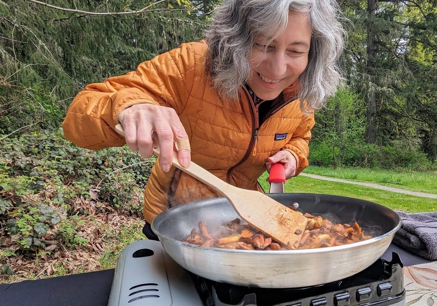 Cooking foraged mushrooms on an outdoor stove